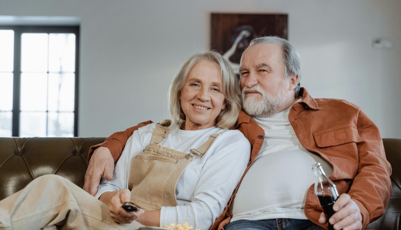 Happy Older Couple Relaxing at Home After Downsizing