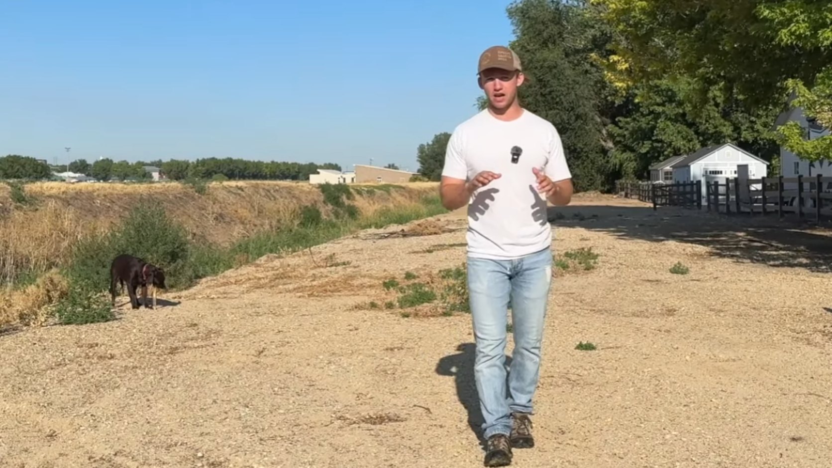 Isaac Crace walking on an irrigation ditch explaining the 10 mistakes buyers can make  when buying an acreage property in Idaho